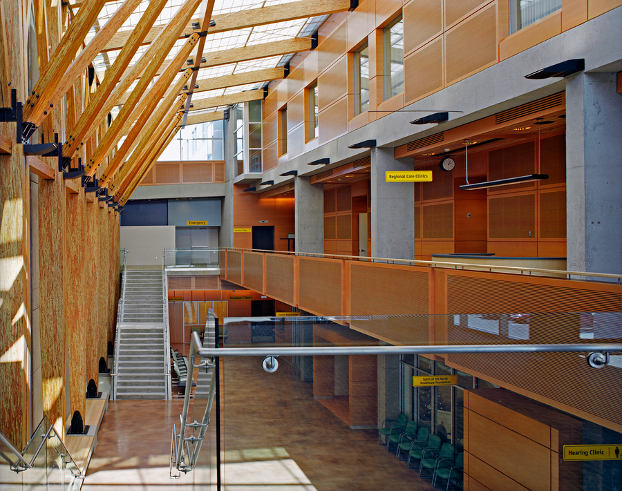 Prince George Airport atrium showing wood beams and trusses with staircase and walkways